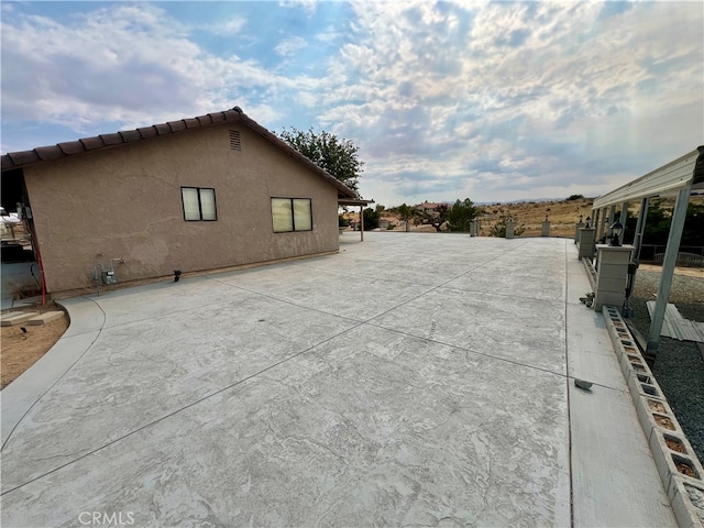 view of side of property with a patio