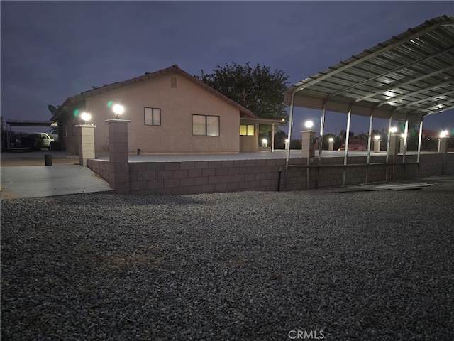 view of side of property featuring a carport