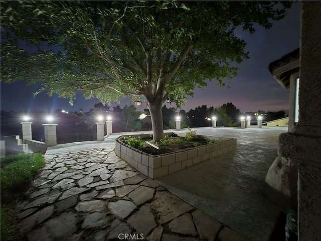 view of patio terrace at dusk