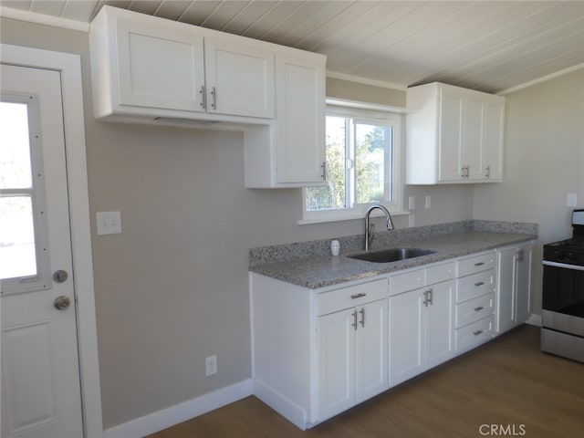 kitchen with white cabinetry, dark hardwood / wood-style flooring, stove, ornamental molding, and sink