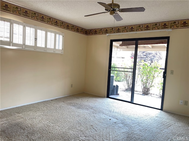 unfurnished room with a textured ceiling, ceiling fan, and carpet floors