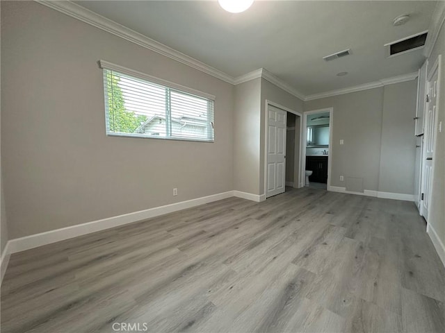 unfurnished bedroom featuring light hardwood / wood-style flooring, a closet, and ornamental molding