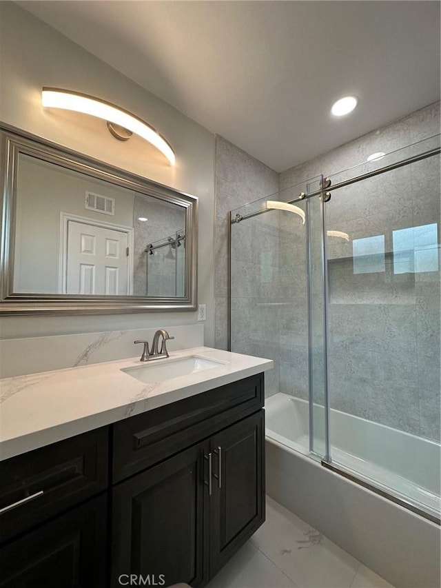 bathroom with shower / bath combination with glass door and vanity