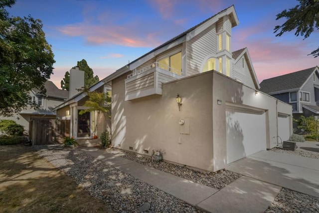 view of front of house featuring a garage and a balcony