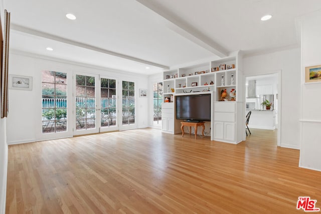 unfurnished living room with beamed ceiling, light hardwood / wood-style floors, and crown molding