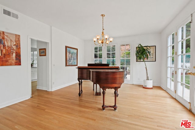 miscellaneous room with a chandelier, french doors, and light hardwood / wood-style flooring