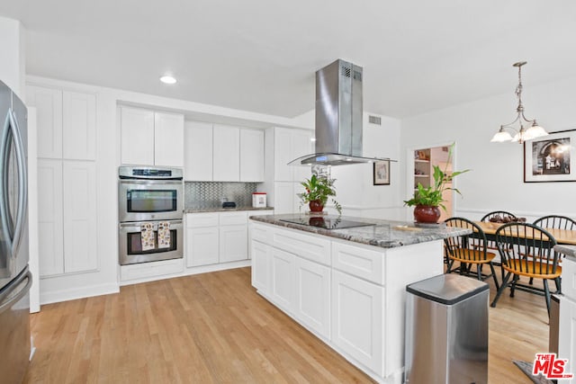 kitchen featuring white cabinets, island range hood, and light hardwood / wood-style flooring