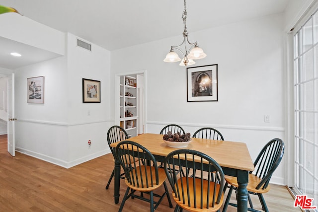 dining room featuring a chandelier and light wood-type flooring