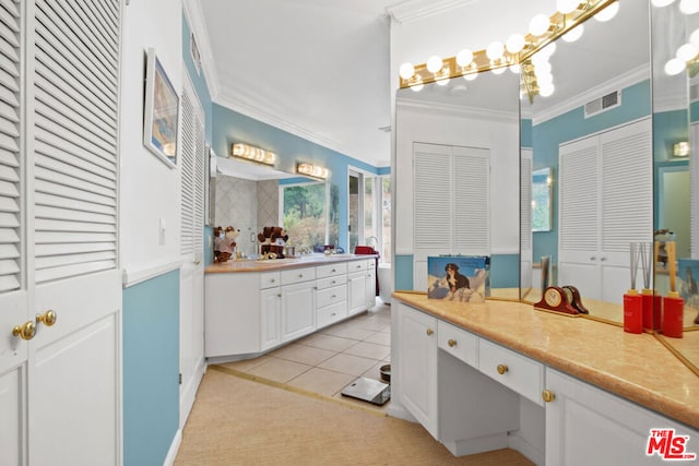 bathroom featuring tile patterned flooring, vanity, and crown molding