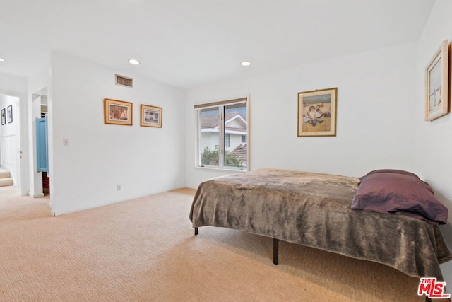 bedroom featuring light colored carpet