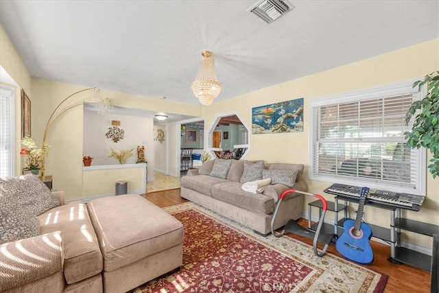 living room featuring a notable chandelier and hardwood / wood-style floors