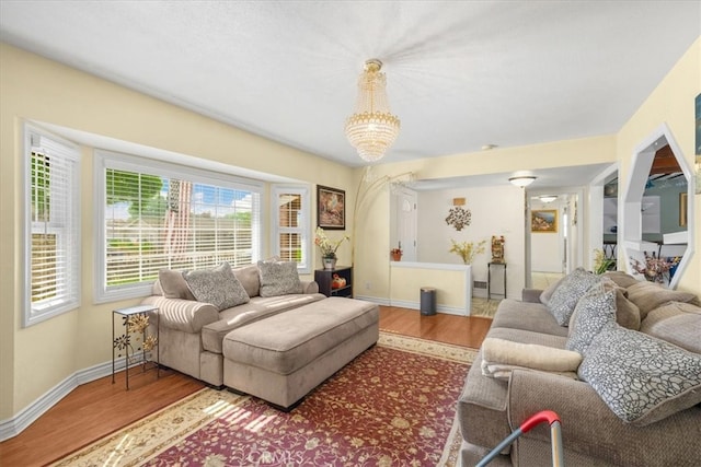 living room with wood-type flooring and a notable chandelier