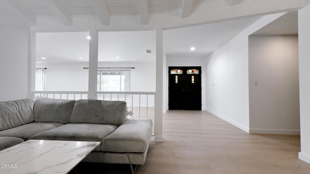 living room with light hardwood / wood-style floors and beam ceiling