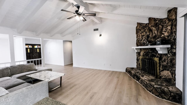 living room featuring vaulted ceiling with beams, ceiling fan, a fireplace, and hardwood / wood-style floors