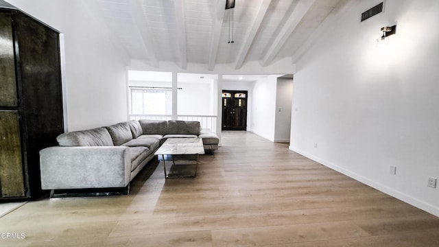 living room featuring light wood-type flooring and beam ceiling