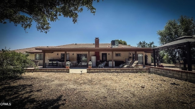 rear view of house with a gazebo, a patio area, and central air condition unit