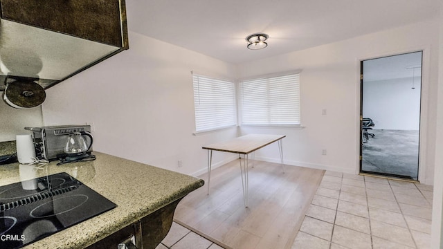 kitchen featuring light hardwood / wood-style flooring and black electric stovetop