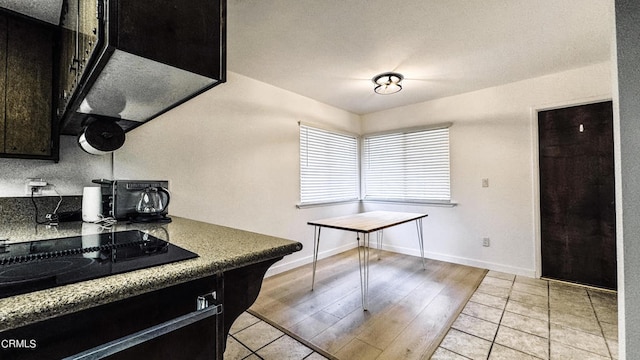 kitchen with black electric stovetop and light hardwood / wood-style floors