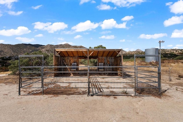 view of horse barn featuring a mountain view