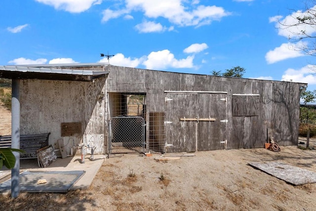 back of house with an outdoor structure