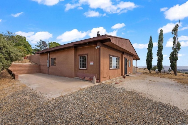 view of side of property featuring a patio area