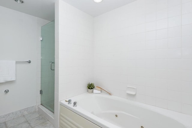 bathroom featuring independent shower and bath and tile patterned flooring