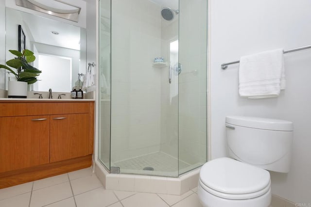 bathroom with vanity, tile patterned flooring, an enclosed shower, and toilet