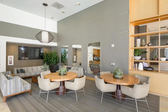 dining area with a high ceiling