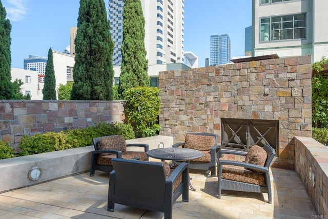 view of patio / terrace with an outdoor stone fireplace