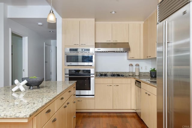 kitchen with light stone counters, light hardwood / wood-style floors, appliances with stainless steel finishes, extractor fan, and light brown cabinetry