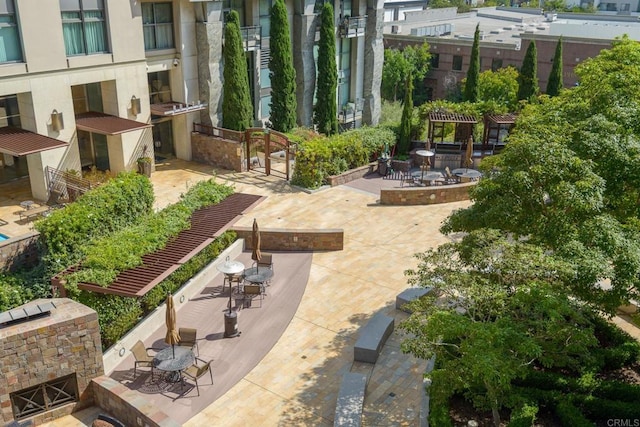 surrounding community featuring exterior kitchen and a patio area