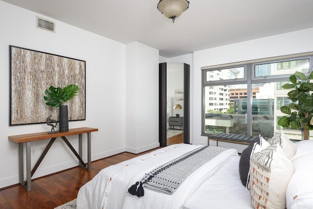 bedroom with dark hardwood / wood-style floors