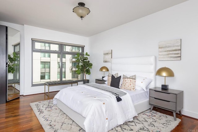 bedroom with dark wood-type flooring