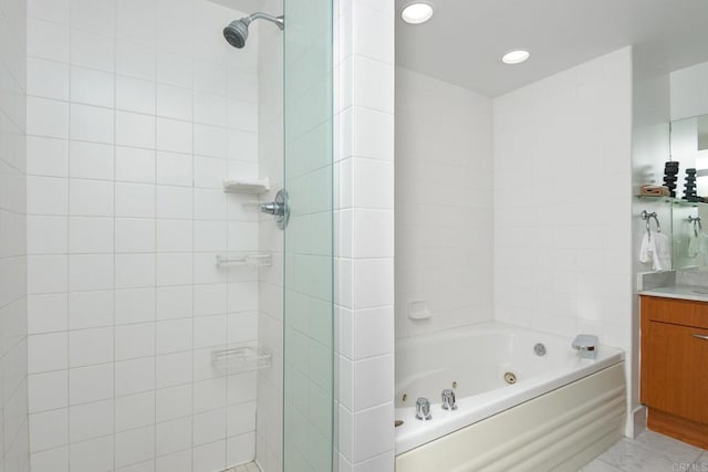 bathroom with vanity and tiled shower / bath