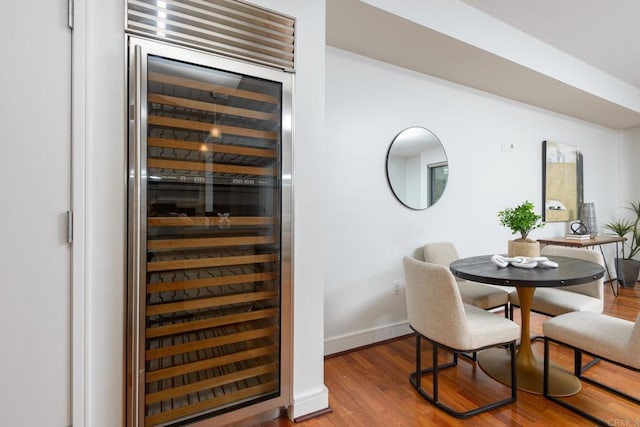 dining room with wood-type flooring and wine cooler