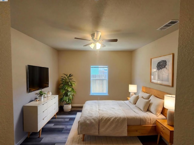 bedroom with ceiling fan and dark wood-type flooring