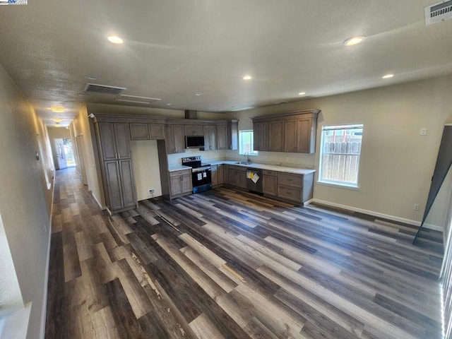 kitchen with dark hardwood / wood-style flooring, stainless steel appliances, and sink