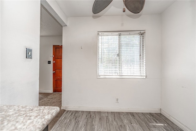 unfurnished bedroom with ceiling fan and hardwood / wood-style floors