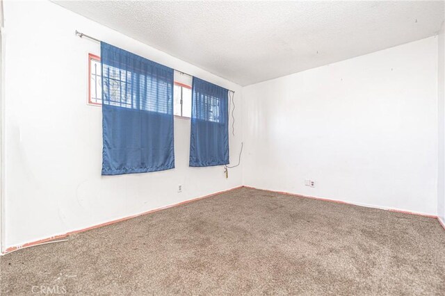 11 Hickock Ln, Carson, CA 90745 - carpeted spare room with baseboards and a textured ceiling