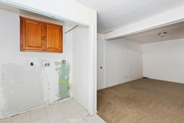 laundry room featuring light colored carpet