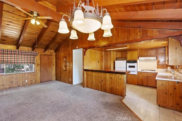 kitchen featuring ceiling fan with notable chandelier, lofted ceiling with beams, wood ceiling, and white appliances