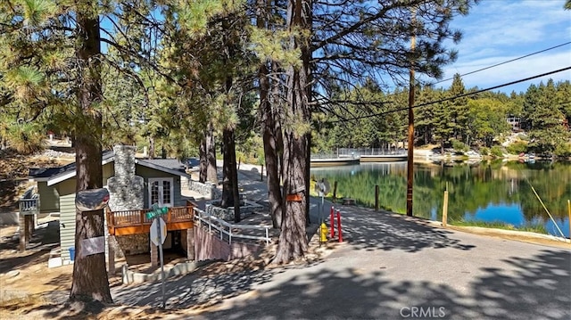 exterior space featuring a deck with water view