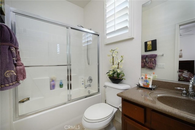 full bathroom with shower / bath combination with glass door, vanity, and toilet