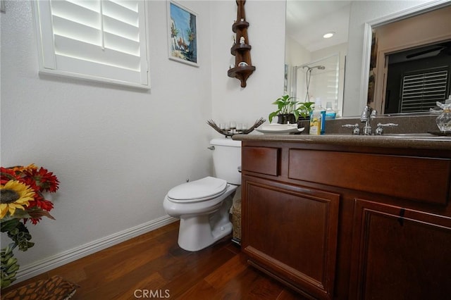 bathroom with toilet, vanity, walk in shower, and hardwood / wood-style floors