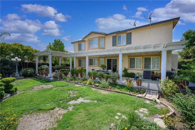 back of property with a yard and a pergola