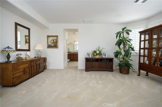 sitting room featuring light carpet