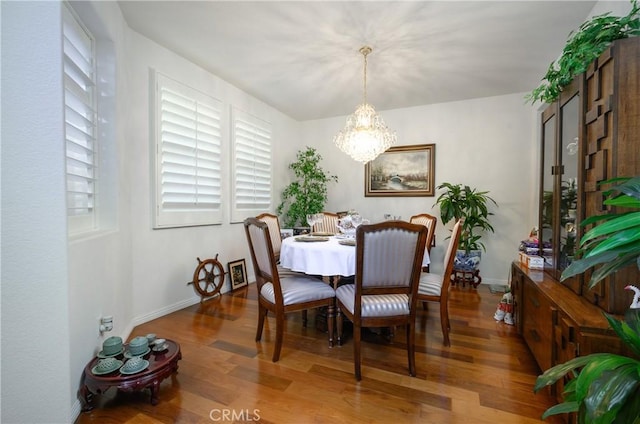 dining area with a notable chandelier and wood-type flooring