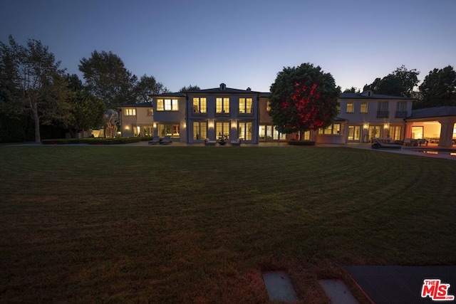 view of front of property with a lawn