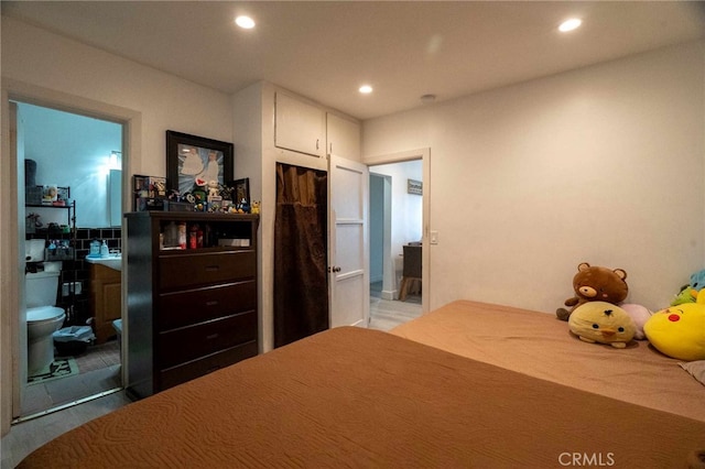 bedroom with ensuite bathroom and a closet