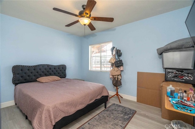 bedroom with light hardwood / wood-style flooring and ceiling fan